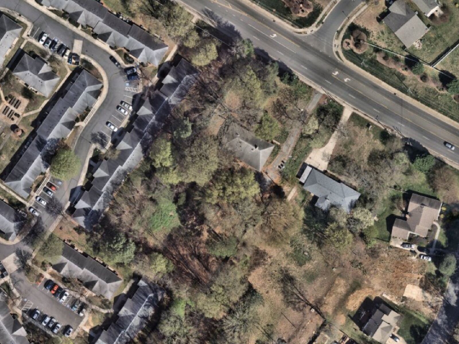 Aerial view of 7214 Lawyers Rd, Charlotte NC, shown adjacent to a 19-unit townhome development on the west side of the parcel.